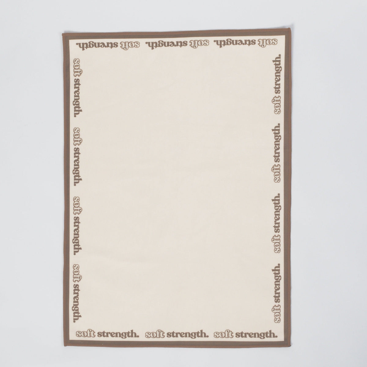 A rectangular cream-colored card with a brown border, featuring the word 'salt strength.' printed repeatedly along the border, displayed flat against a light gray background.